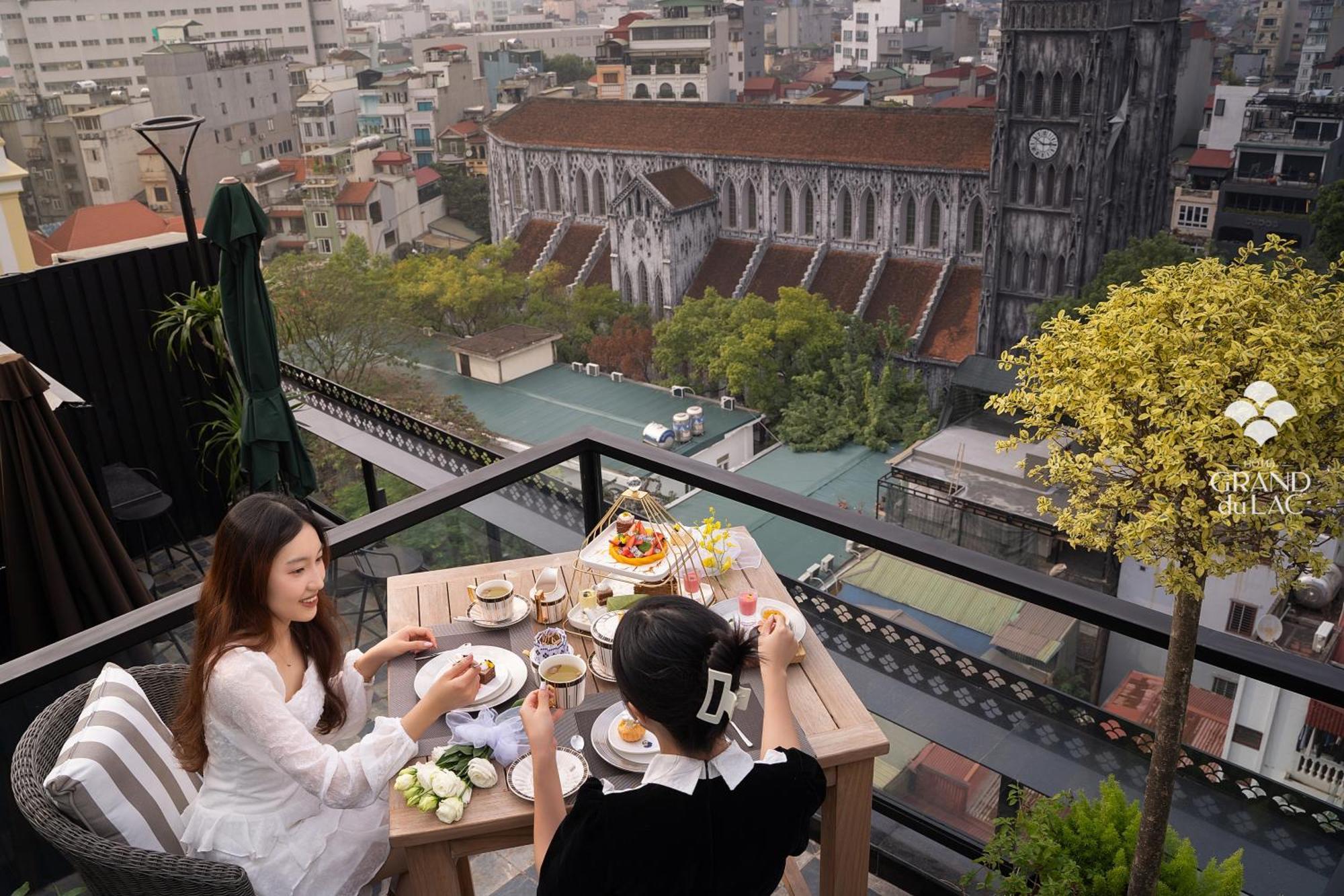 Grand Hotel Du Lac Hanoi Exterior photo The view of the Saigon River from the rooftop bar